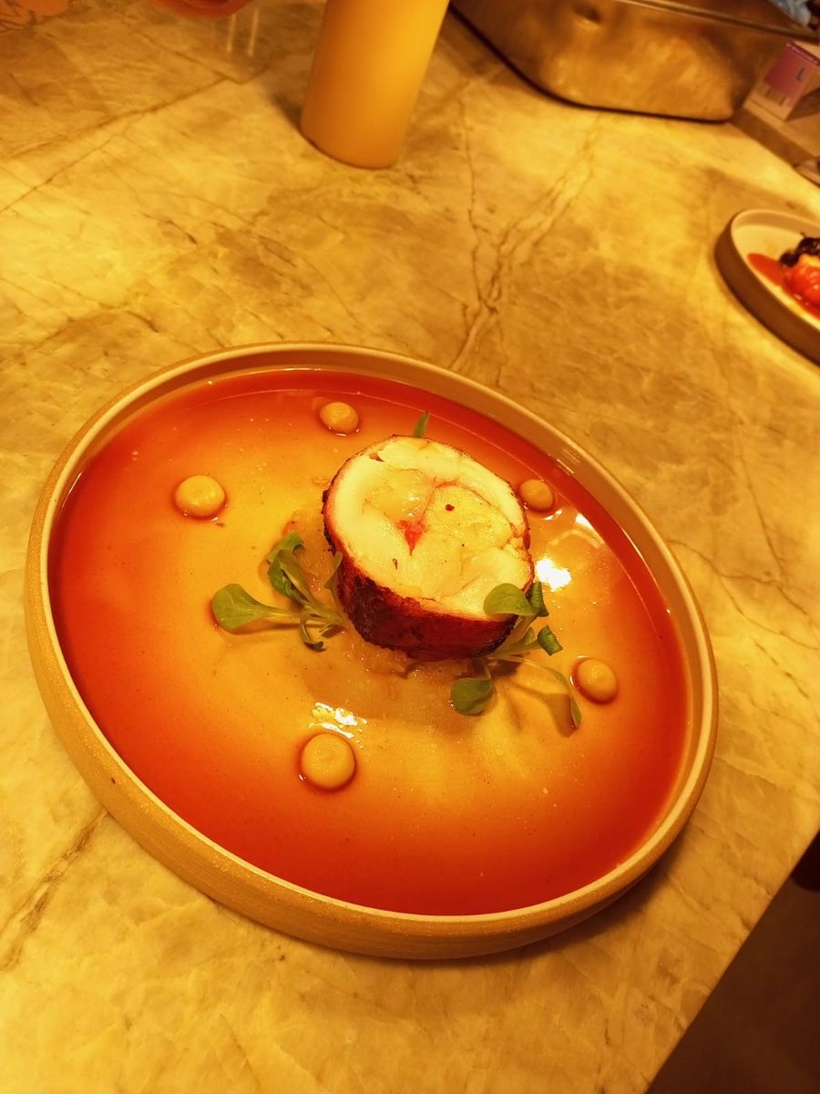 Crayfish tail served in a shellfish bisque with carrot gel