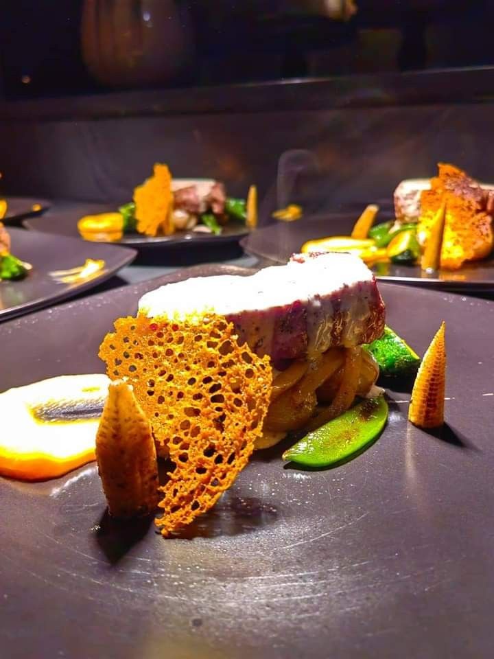 Plated pork loin with a parmesan tuile and glazed vegetables